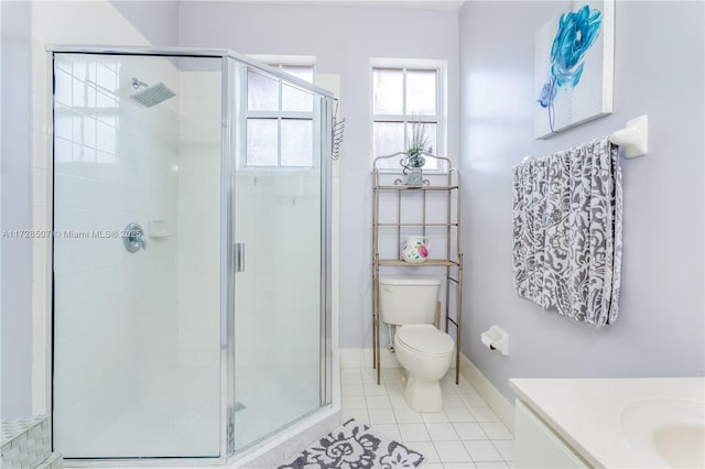 bathroom with vanity, tile patterned flooring, a shower with shower door, and toilet