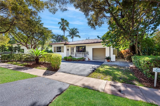 view of front of house featuring a garage and a front lawn