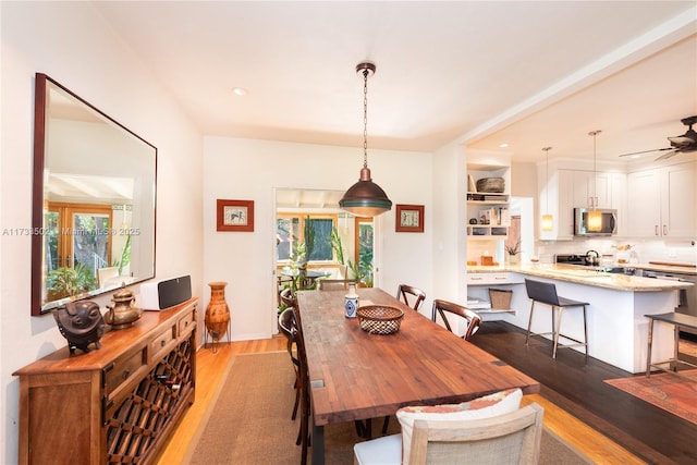 dining room with ceiling fan, plenty of natural light, and light wood-type flooring