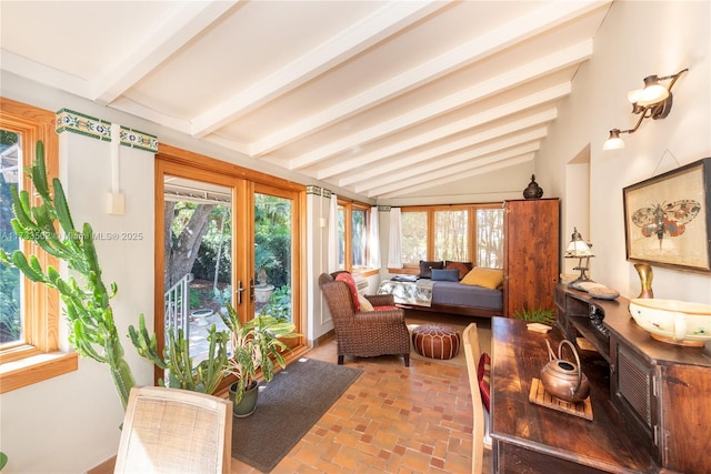 sunroom / solarium with a healthy amount of sunlight and vaulted ceiling with beams