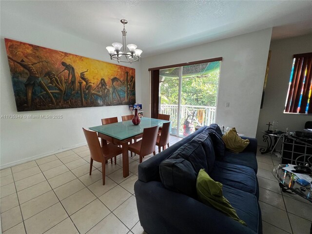 dining space featuring light tile patterned floors and a chandelier