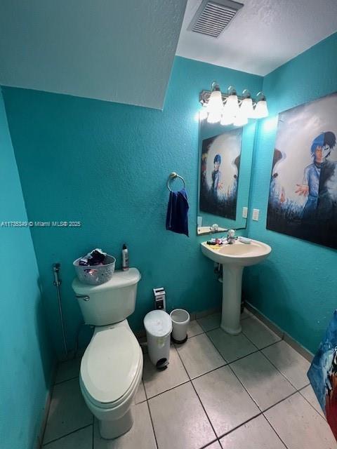 bathroom featuring tile patterned floors and toilet