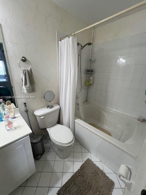 full bathroom featuring vanity, toilet, tile patterned flooring, and shower / tub combo