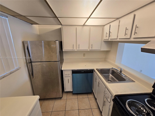 kitchen featuring appliances with stainless steel finishes, white cabinetry, sink, light tile patterned floors, and wall chimney range hood