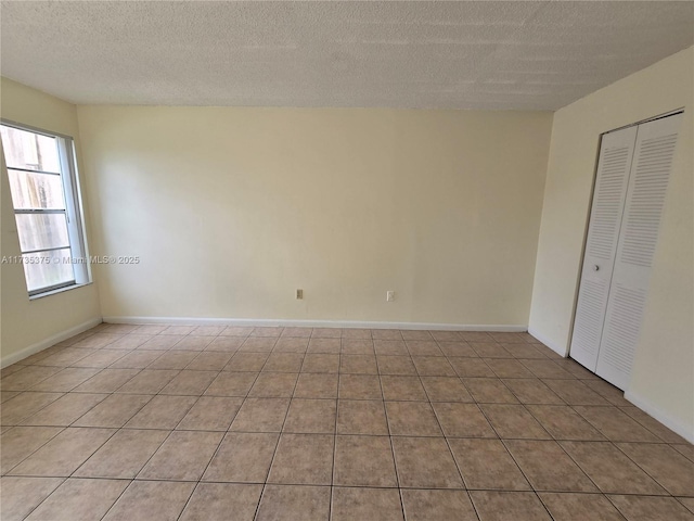 unfurnished room featuring a textured ceiling