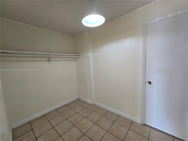 spacious closet with light tile patterned floors