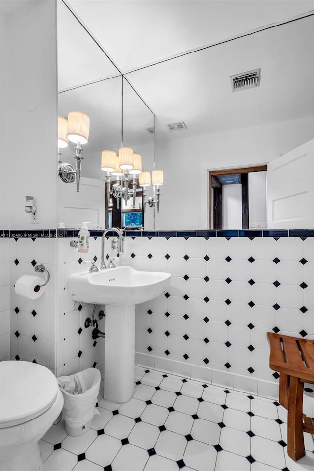 bathroom with tile walls and toilet