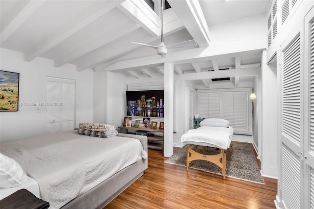 bedroom featuring vaulted ceiling with beams and hardwood / wood-style flooring