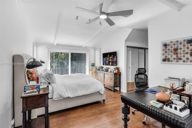 bedroom with ceiling fan, wood-type flooring, a closet, and vaulted ceiling with beams