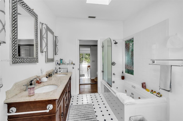 bathroom featuring vanity and a skylight