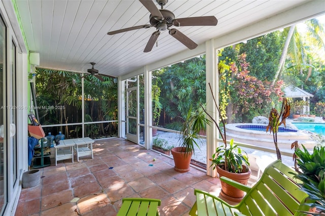 unfurnished sunroom with wood ceiling and ceiling fan