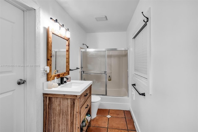 full bathroom featuring enclosed tub / shower combo, vanity, toilet, and tile patterned flooring