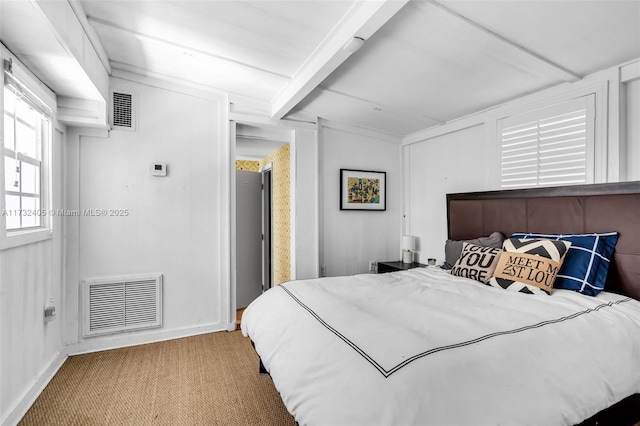 bedroom featuring beamed ceiling and carpet floors