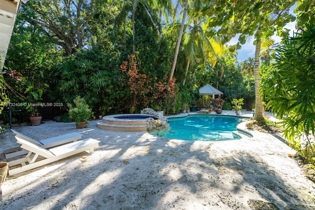 view of swimming pool with a patio area and an in ground hot tub