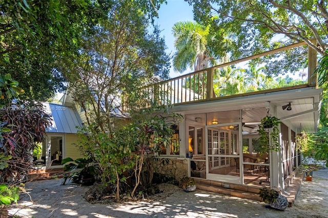 back of property with a sunroom