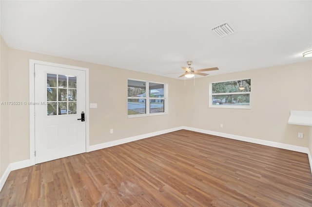 spare room featuring hardwood / wood-style flooring and ceiling fan