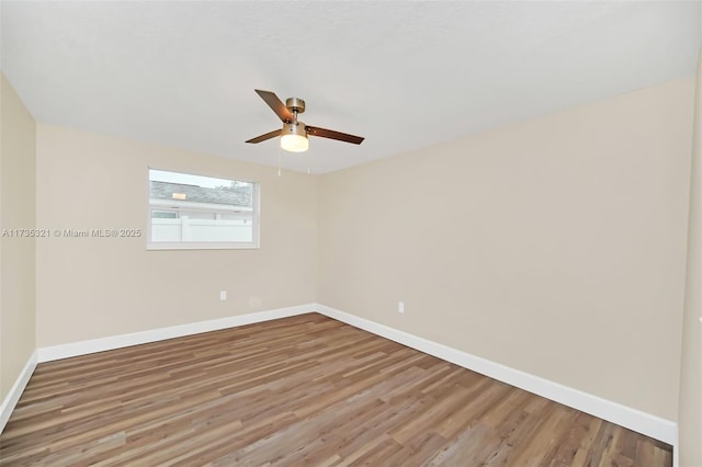 spare room featuring hardwood / wood-style flooring and ceiling fan