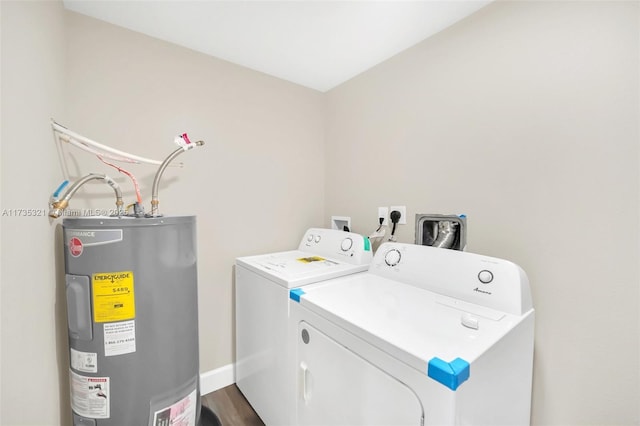 laundry room with dark wood-type flooring, washing machine and dryer, and water heater