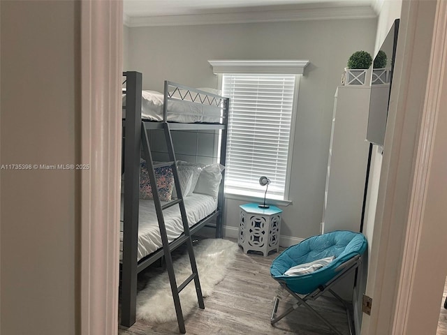 bedroom featuring crown molding and hardwood / wood-style flooring