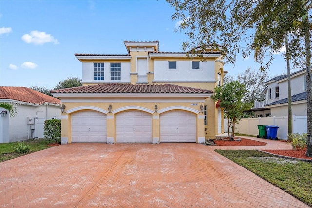 mediterranean / spanish house with a garage