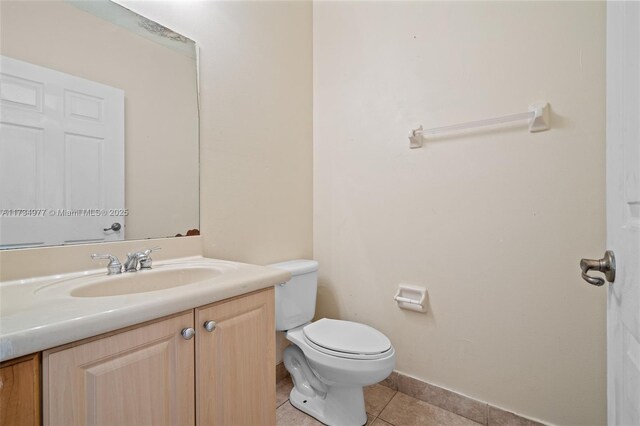 bathroom with vanity, tile patterned floors, and toilet