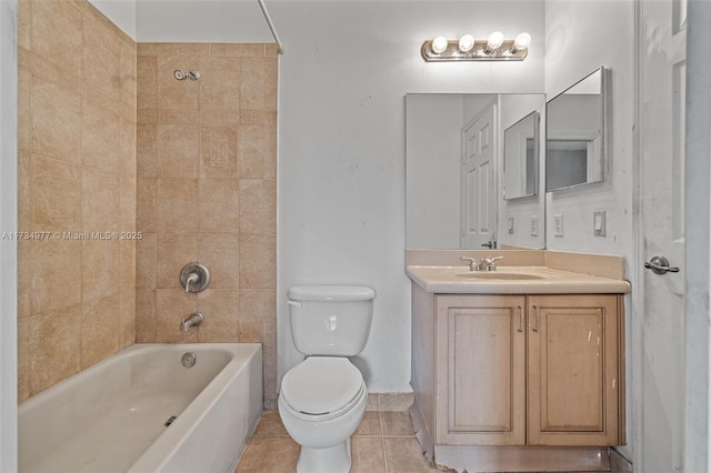 full bathroom featuring tiled shower / bath, vanity, tile patterned floors, and toilet