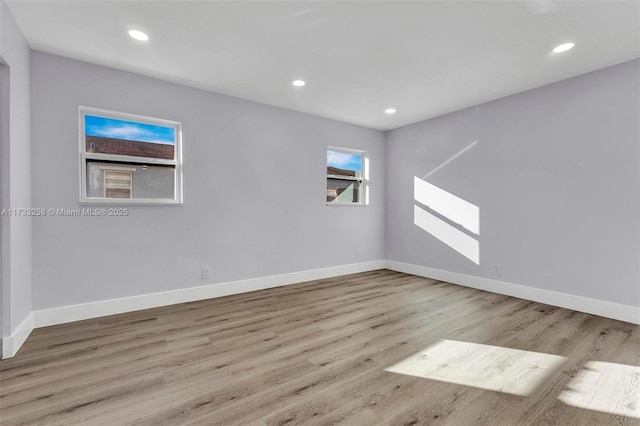 spare room with light hardwood / wood-style flooring