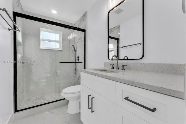 bathroom featuring walk in shower, vanity, and toilet