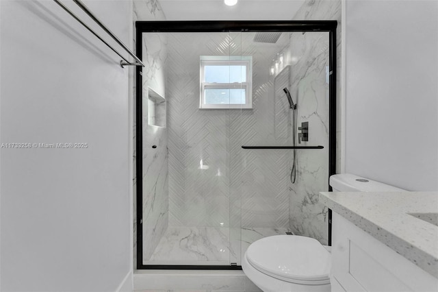 bathroom with vanity, toilet, and walk in shower