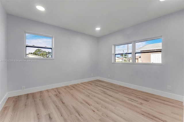 unfurnished room with plenty of natural light and light hardwood / wood-style floors