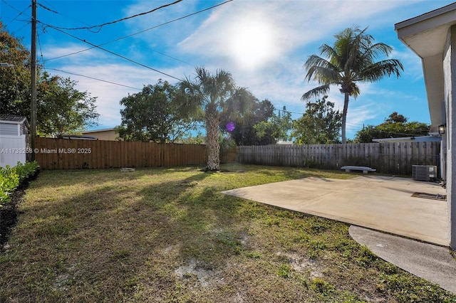 view of yard with central AC unit and a patio area