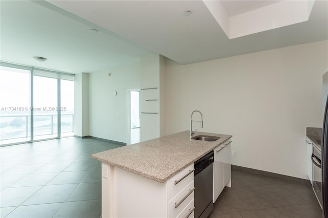 kitchen featuring sink, white cabinetry, a center island with sink, stainless steel dishwasher, and expansive windows