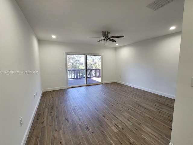 unfurnished room with recessed lighting, dark wood-style flooring, visible vents, and baseboards