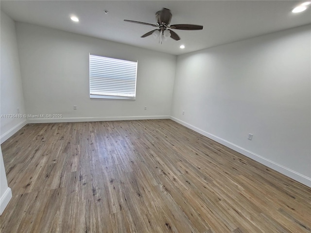 empty room with a ceiling fan, recessed lighting, baseboards, and light wood finished floors