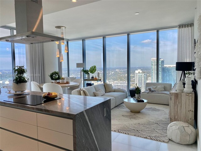 tiled living room with floor to ceiling windows