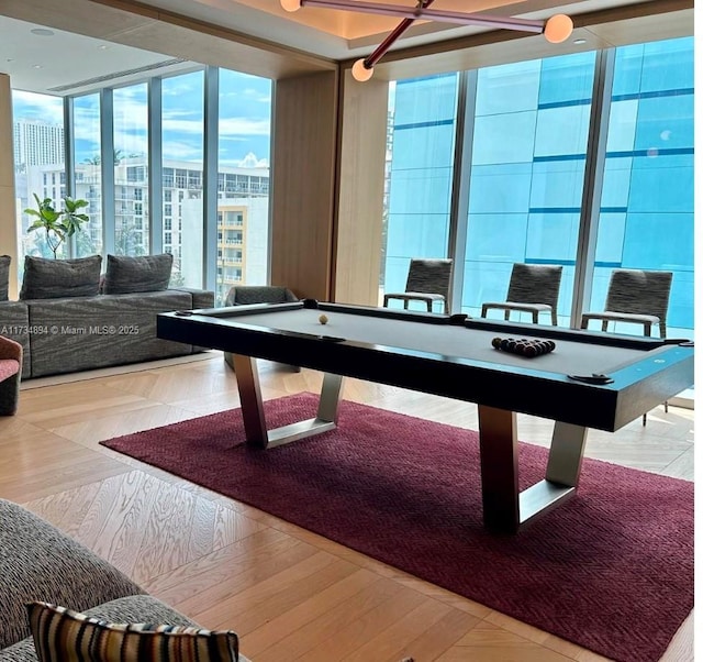 playroom featuring pool table, light parquet flooring, and a wall of windows