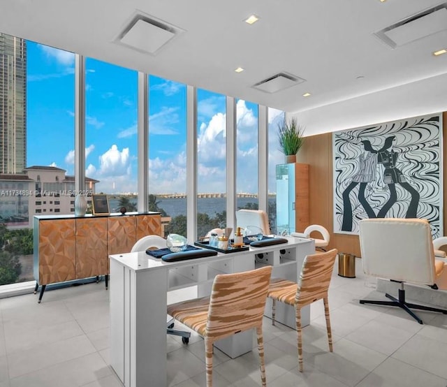 sunroom / solarium featuring a wealth of natural light and a water view