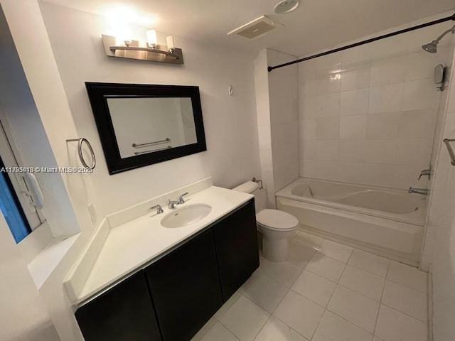 full bathroom featuring vanity, tiled shower / bath combo, tile patterned floors, and toilet