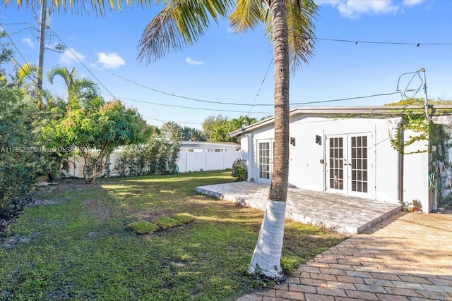 view of yard with a patio and french doors