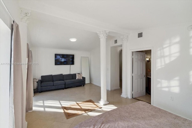 living room featuring light tile patterned floors and decorative columns