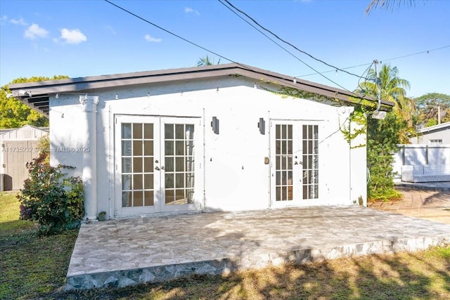 back of property with french doors and a patio area