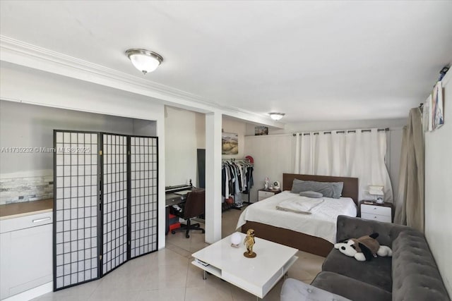 tiled bedroom with a spacious closet