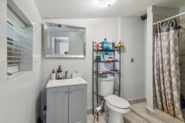 bathroom with vanity, toilet, hardwood / wood-style floors, and a shower with curtain