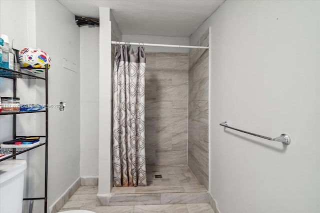 bathroom featuring toilet and a shower with shower curtain