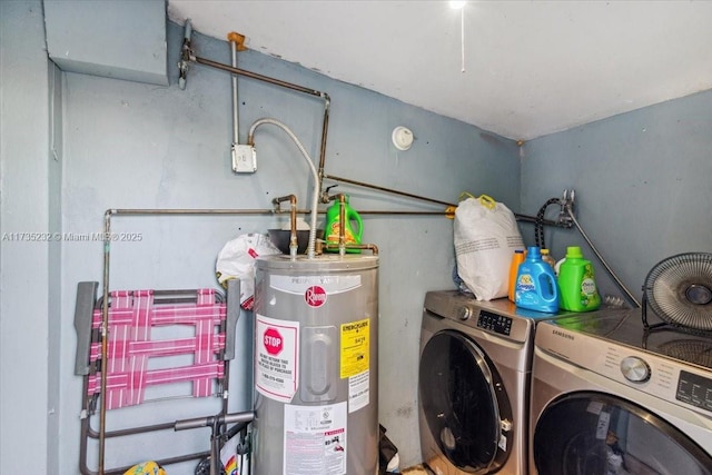 laundry area with washer and clothes dryer and electric water heater