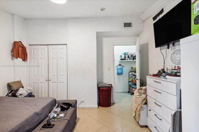 tiled bedroom with a closet