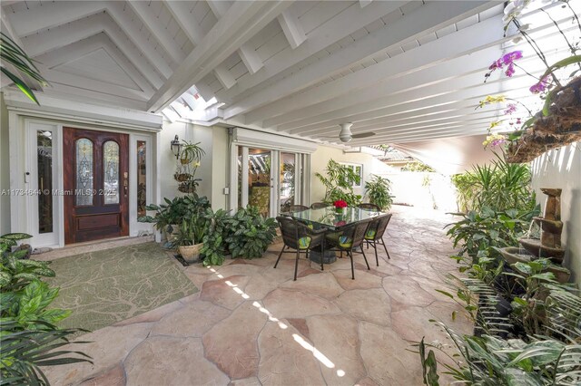 sitting room featuring a notable chandelier, light tile patterned floors, lofted ceiling with beams, and wooden ceiling