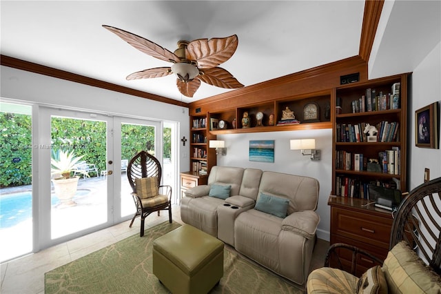 tiled living room featuring ornamental molding, ceiling fan, and french doors