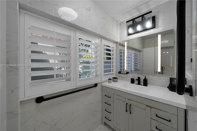 bathroom with vanity and tile walls