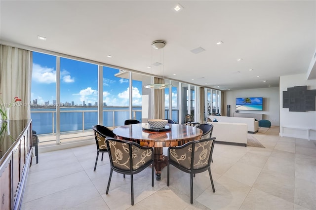 dining space with floor to ceiling windows and light tile patterned floors